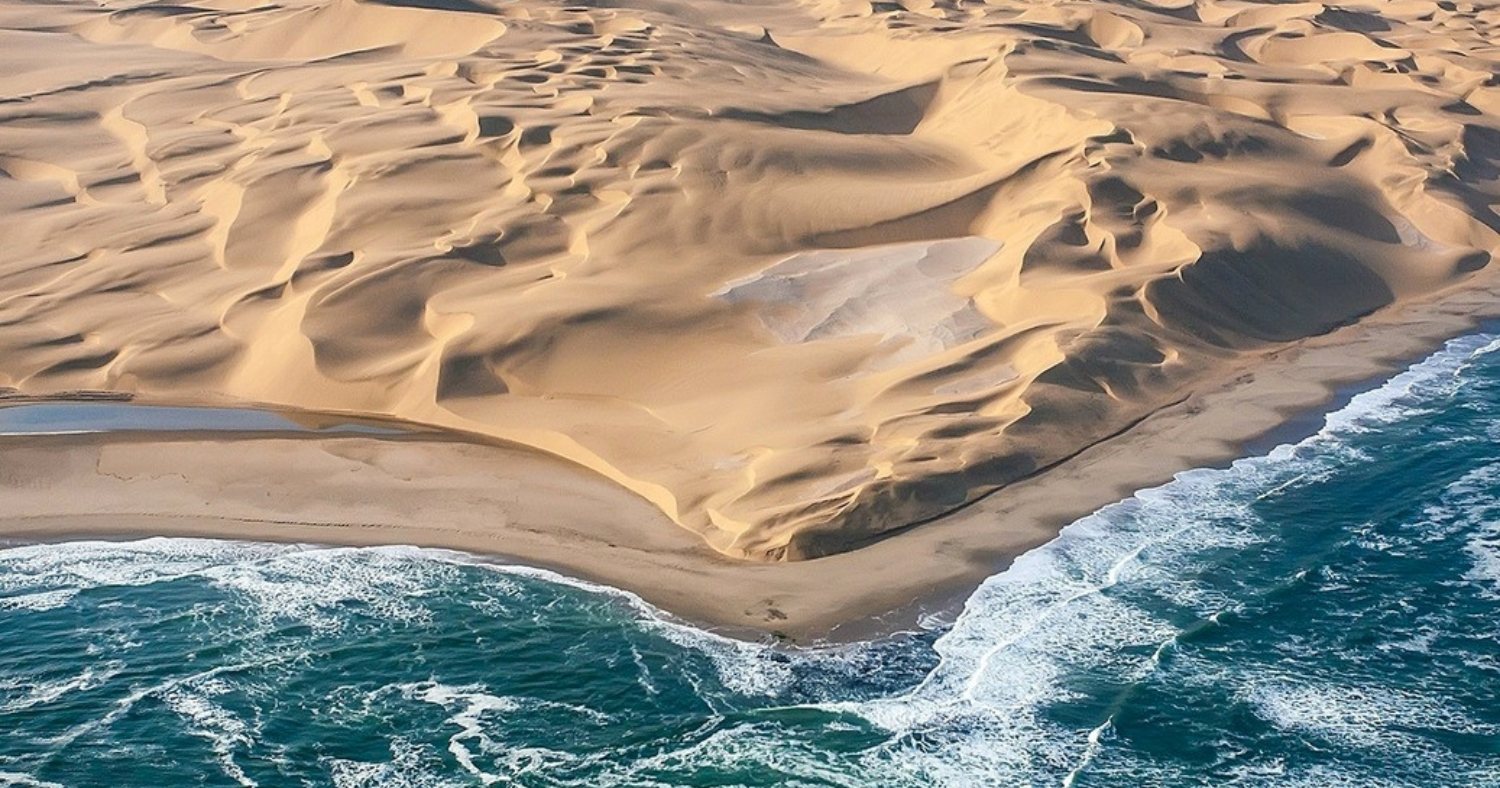 Aerial view of the Namib dunes meeting the Atlantic